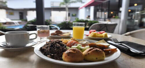 Picture of a wonderful meal served poolside by the Costa Rica Medical Center Inn in beautiful Costa Rica.  The picture shows a full course meal served with coffee and juice.