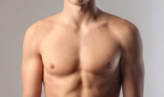 Picture of a man showing his chest and happy with his perfect male breast reduction procedure he had at Top Plastic Surgeons in beautiful San Jose, Costa Rica.  The man is shirtless and facing the camera and standing against a light purple background.